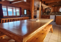 8 foot oak table with open concept kitchen/living room space