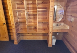 Built-in shelves with a sink and mirror in all bedrooms