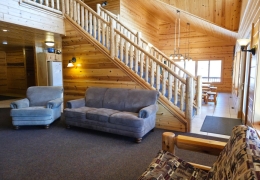 Grand staircase separates kitchen and living room space