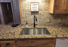 Lower level kitchen with quartz countertop & farmhouse sink