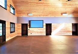 Speaker and 9' Projection Screen in large meeting space