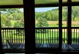 Walk out covered deck to watch kids and young-at-heart play sand volleyball