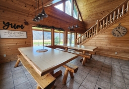 Two 8 foot log tables in large open kitchen area