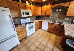 Modern kitchen stocked with baking & cooking essentials (pots, pans, dishes, stemware, etc)