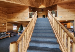 Stunning staircase separates kitchen and living room