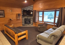 Living room complete with gas fireplace and futon sleeper (linens included)