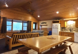 Open concept living room & kitchen space with an 8 ft log table