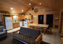 Open concept living room & kitchen space with an 8 ft log table
