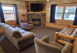 Living room complete with gas fireplace and futon sleeper (linens included)