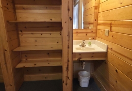 Built-in shelves with a sink and mirror in all bedrooms