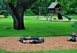 Firepit area and one of four playgrounds at the resort