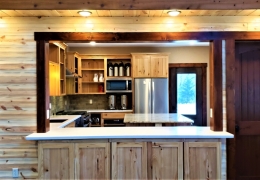 Serving counter with a pull down privacy screen between large event space and kitchen
