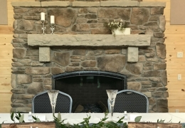 Floor to ceiling stone faced fireplace