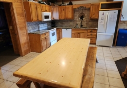 8 foot oak table in open concept kitchen and living room