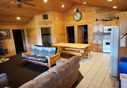 Spacious living room & kitchen space with an 8 ft log table