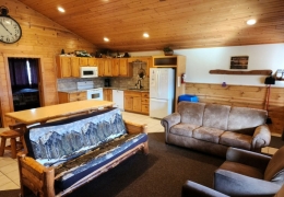 Open concept living room & kitchen space with an 8 ft log table