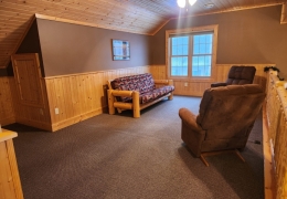 Upper level loft area with futon bed (linens & pillows included)