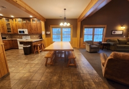 8 foot oak table in open concept kitchen and living room