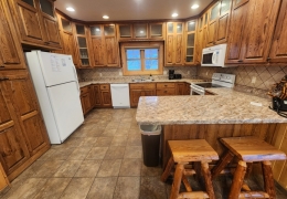 Modern kitchen stocked with baking & cooking essentials (pots, pans, dishes, stemware, etc)
