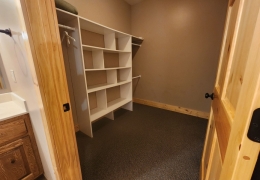 Main level on suite bathroom with separate shower and closet area