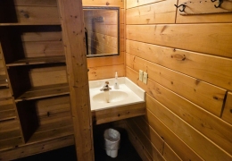 Queen bedroom with built-in storage and private sink and mirror